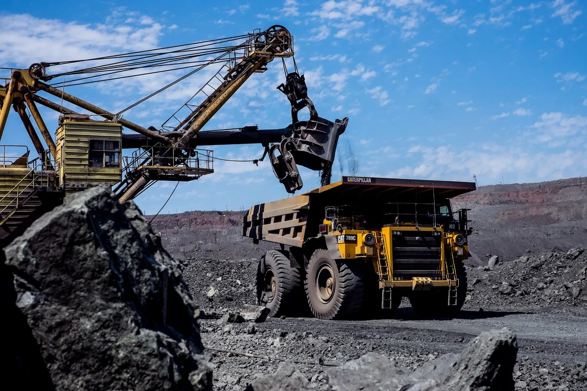 Cable shovel loading a haul truck at an open-pit mine face